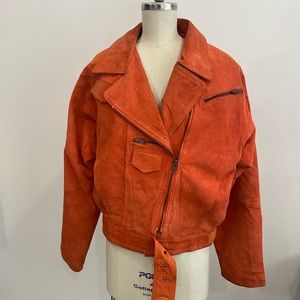 Asymmetrical women’s 1980’s vintage orange leather jacket. Moto style.